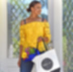 Woman wearing bra with flower straps featuring blue daisy floral details, in yellow lace top, holding a bag with bouquet.