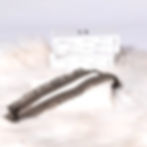 Lace interchangeable decorative bra straps in olive green, laying flat.