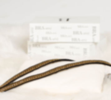 Gold chain bra straps laying flat.