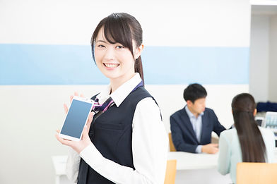 スマホを手に微笑む女性