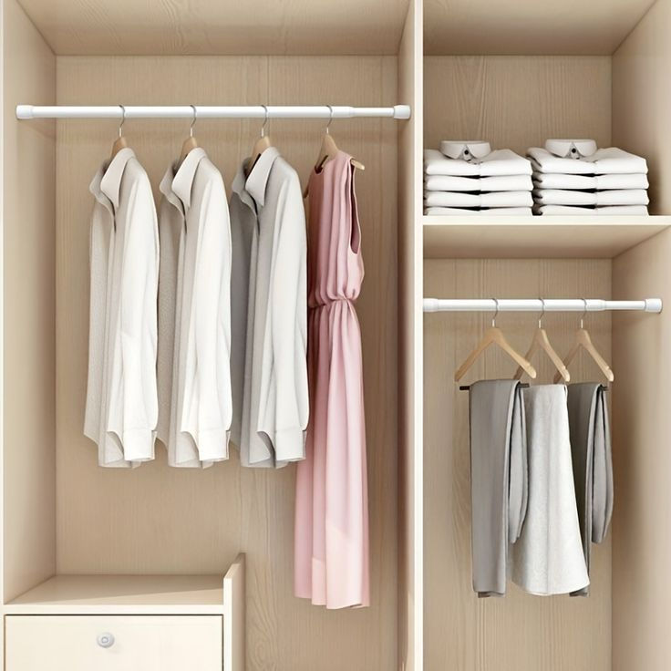 Eye-level view of a minimalist wardrobe with neutral-coloured clothes neatly hung