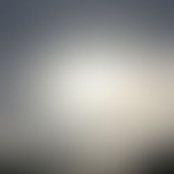 Sunlight breaking through dark storm clouds, symbolizing inner freedom found even in captivity