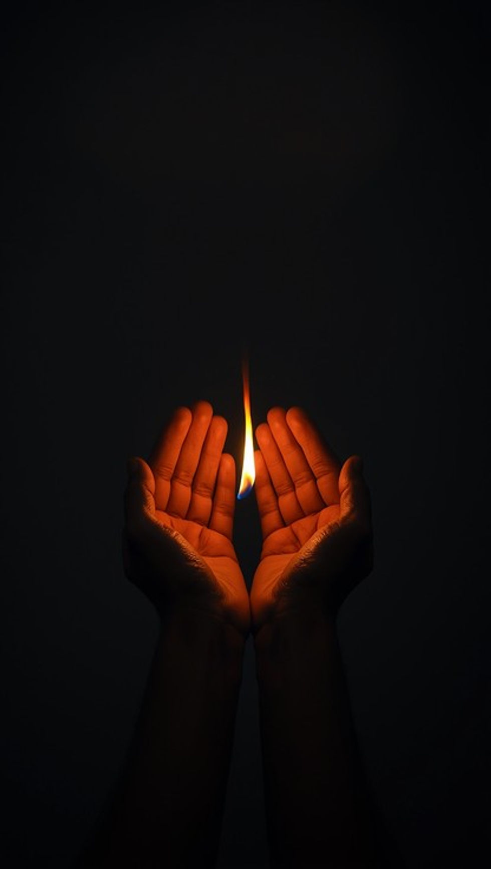 Cupped hands protecting a single glowing flame in darkness, symbolizing courage and hope