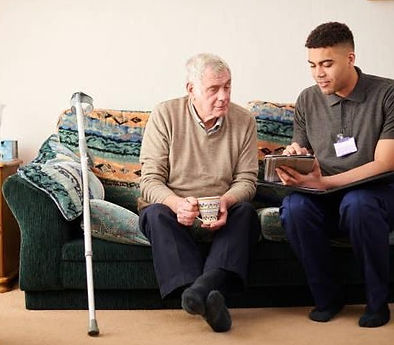 CC Aide helping elderly man.jpg
