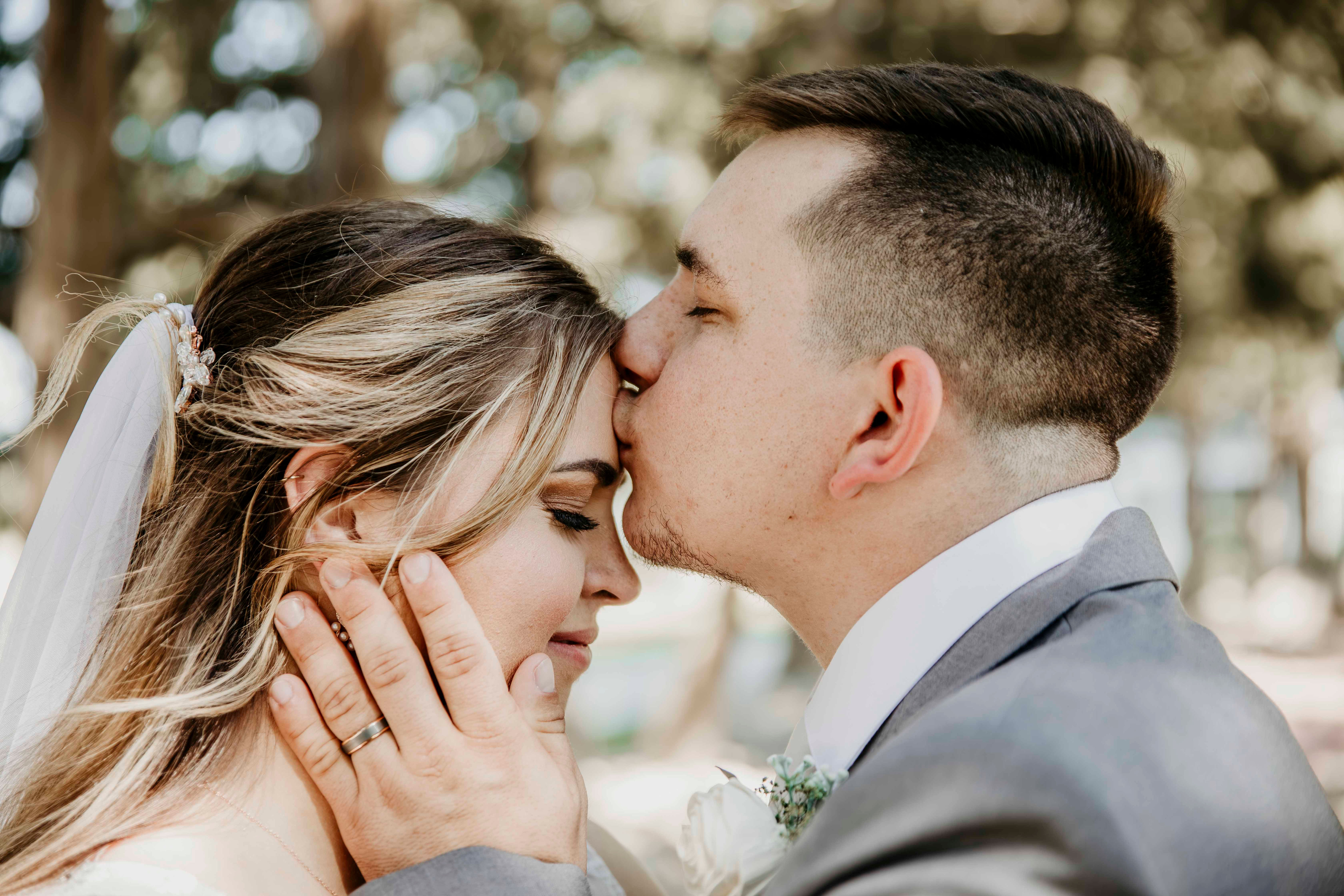 Wedding Video Omaha NE - groom sneaks kiss on brides forehead
