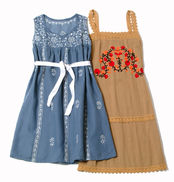Blue embroidered dress with a white sash beside a tan dress with red and orange floral embroidery, styled and phtographed for Teen Magazine by Teresa Elena Lee.