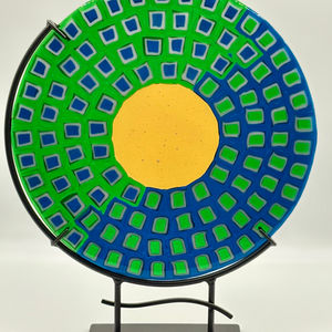 Rectangular black glass art with blue and red accents, FMW ArtGlass, on wooden stand.