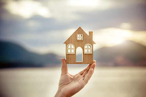 a wooden house in front of a landscape