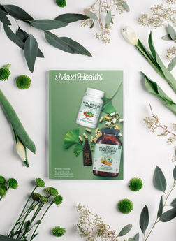 A magazine cover that says "MAXI HEALTH" featuring vitamin bottles and pills surrounded by flowers