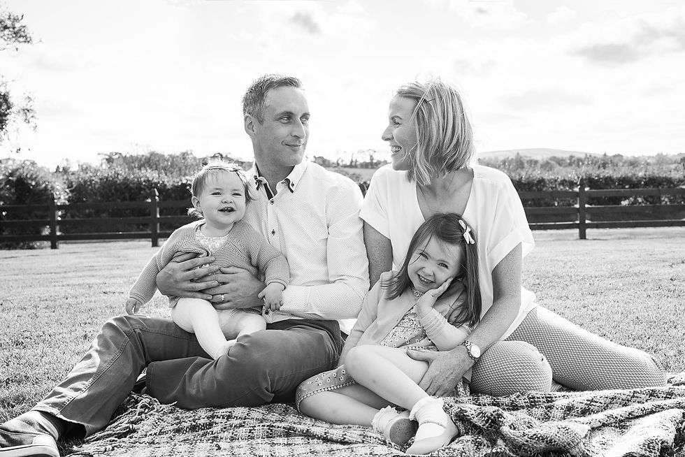 family portrait in black and white, mam and dad looking lovingly at each other. cavan
