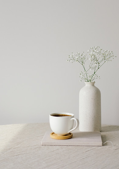 Scandinavian, nordic style home interior decoration. Cup of coffee and vase of flower on l