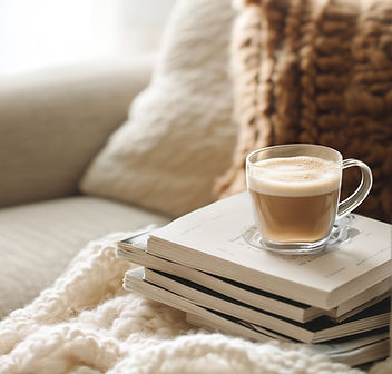 Warm, inviting therapy setting with coffee and books, representing the safe and thoughtful space Dr. Landau creates for eating disorder recovery