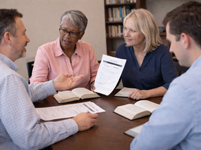 Adult small group discussing Bible passage using printed study discussion guide