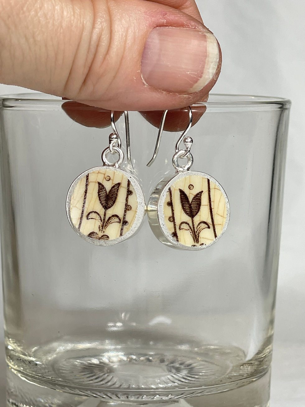 Thumbnail: small round drop earrings with brown floral transferwork
