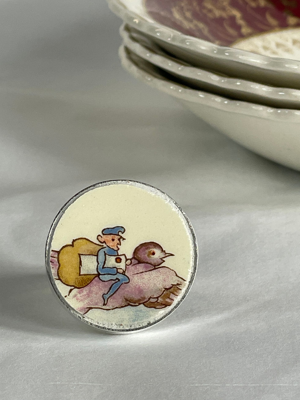 ring with small postman on delivery pigeon. Taken from Bunnykins plates.