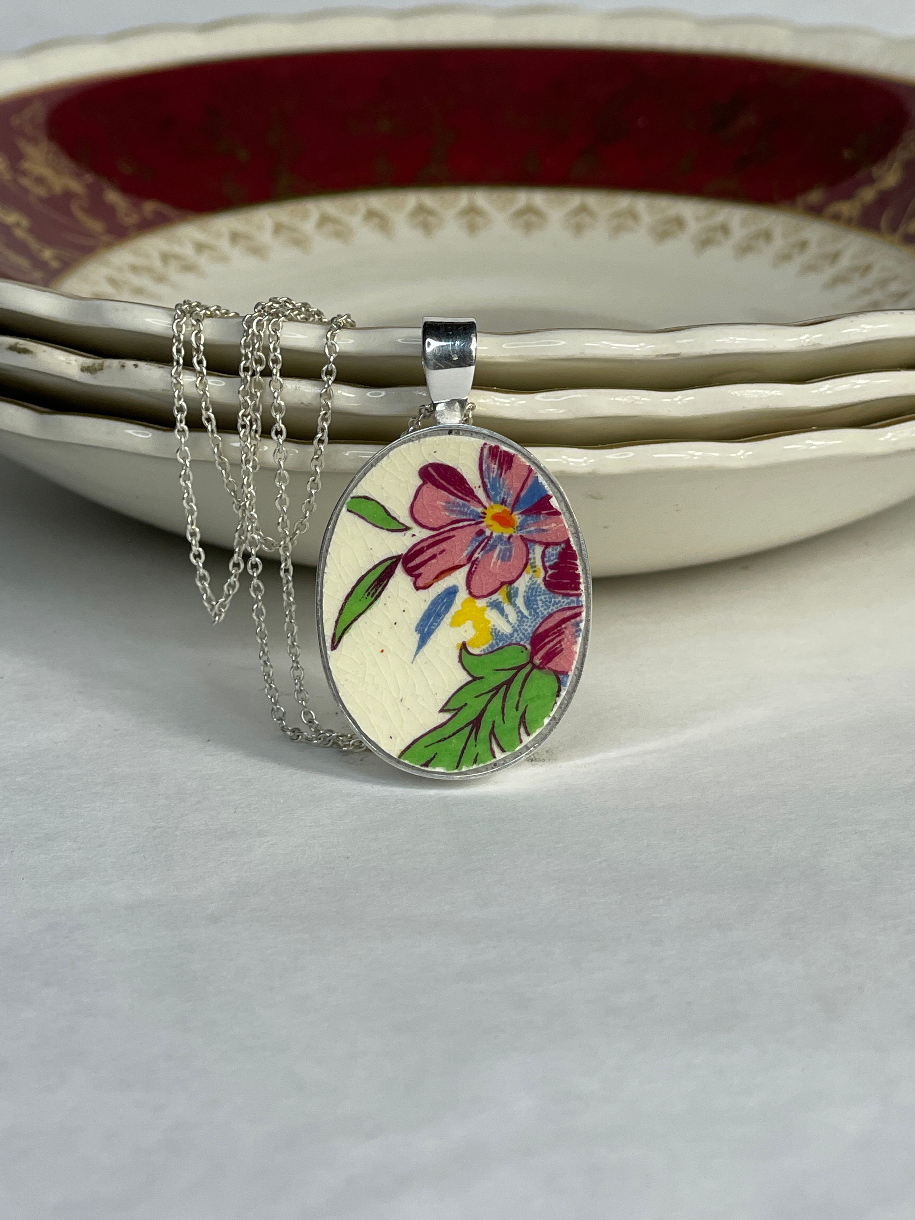 oval pendant with purple flowers