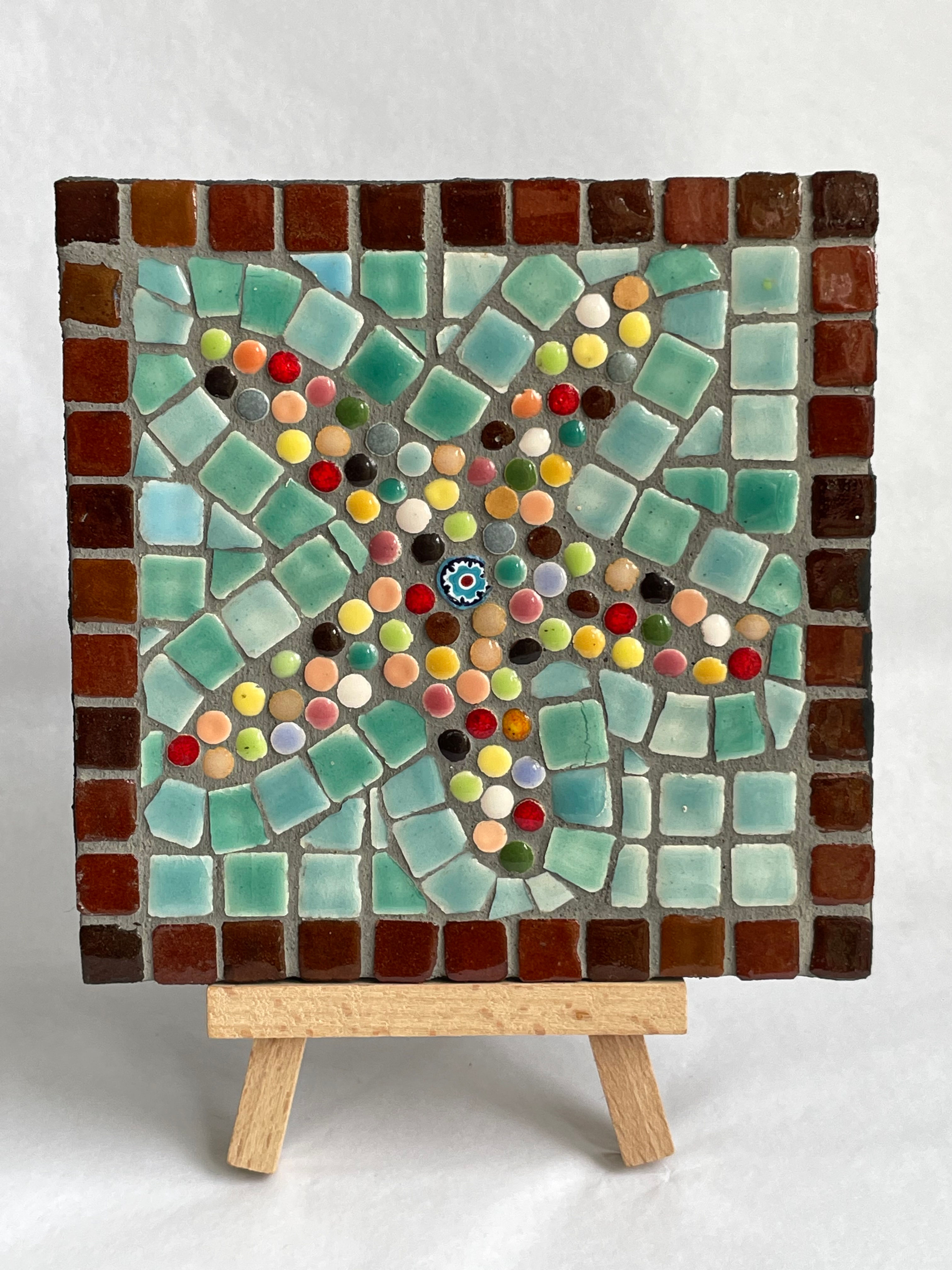 starfish mosaic of tiny multicoloured dots on a green background.