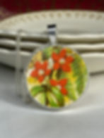 Thumbnail: orange flowers with green leaves in a vintage china pendant
