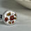 Thumbnail: small round ring with red flowers