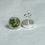 Thumbnail: stud earrings with small green flowers on a white background