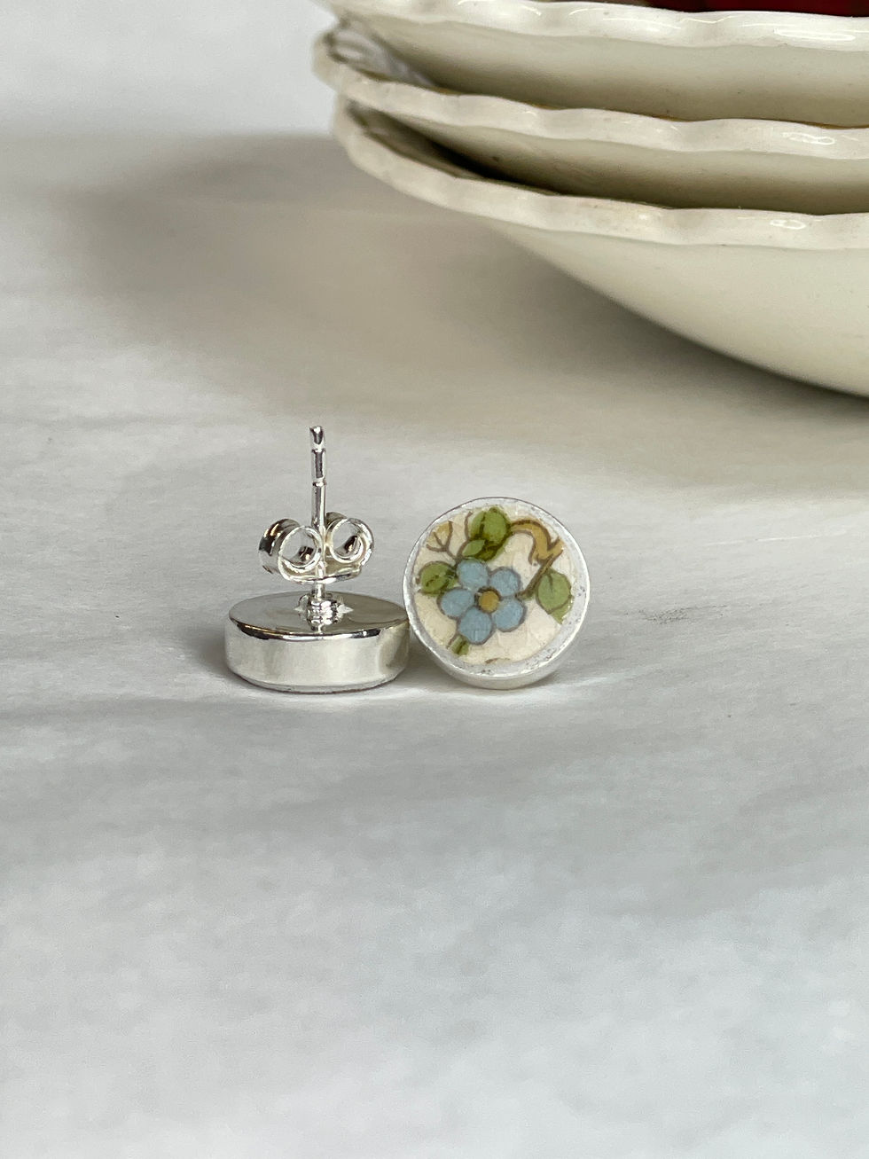 Thumbnail: small round stud earrings with pretty blue flower by Johnson Brothers