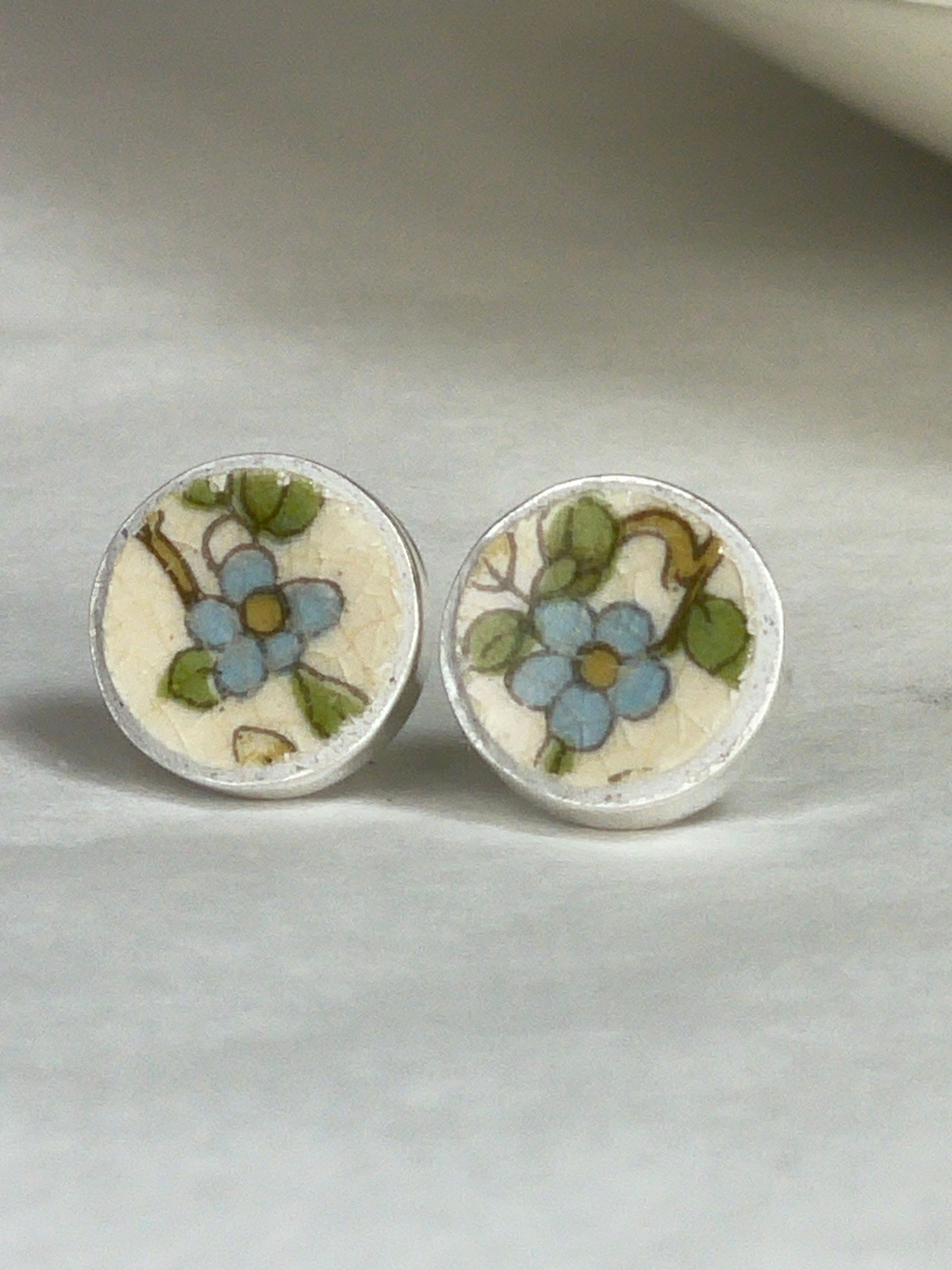 small round stud earrings with pretty blue flower by Johnson Brothers