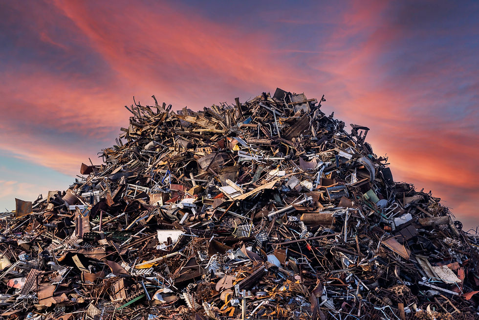 scrap metal heap at recycling junk yard against red sky at sunset.jpg