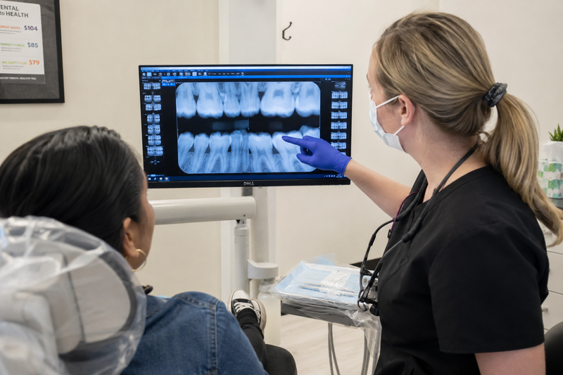 Dental hygienist explaining periodontal disease to a patient