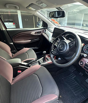 Modern car interior with black and maroon seats