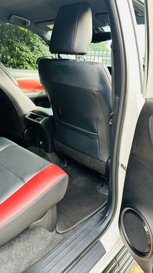 Fortuner Executive Detail: Clean black and red leather car interior.