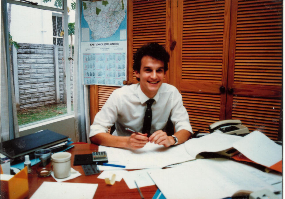 Russell Cullingworth behind his desk as a young accountant