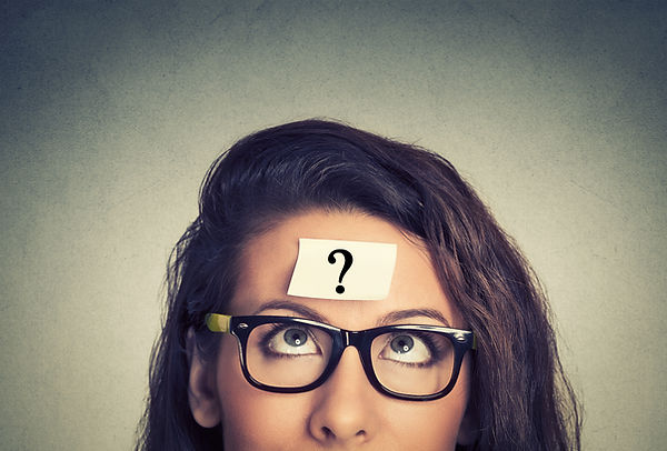 thinking woman with question mark on gray wall background.jpg