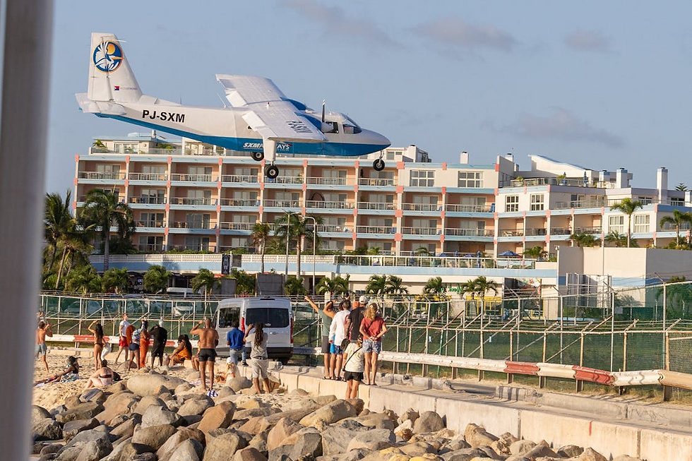 A plane flies low over tourists at Maho Beach, Sint Maarten, near the airport; Sint Maarten | Photo Credit: Jermaine Lewis