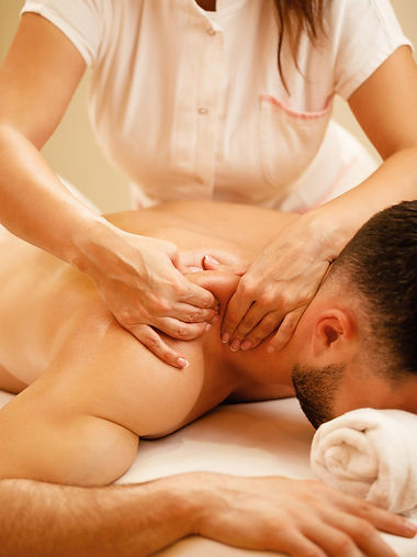 unrecognizable-therapist-massaging-man-s-shoulders-during-spa-treatment.jpg