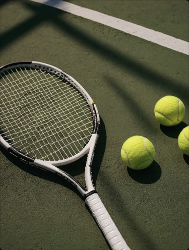 Tennis racket and tennis balls on a green court
