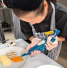A participant practising IDDSI food preparation and testing techniques during a practical training session.