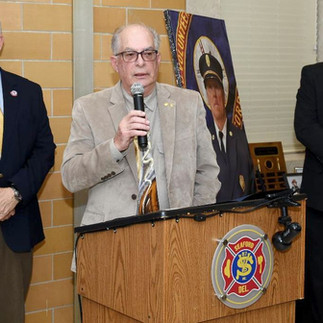 State Rep. Tim Dukes and Fire Department President Mark Obier present the recognition to Rep. Short.