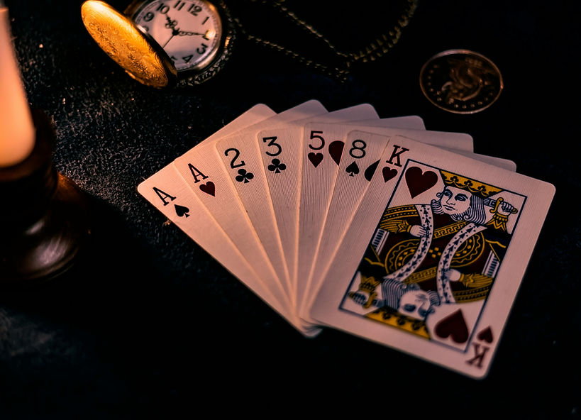 A spread of cards laid on a dark surface.