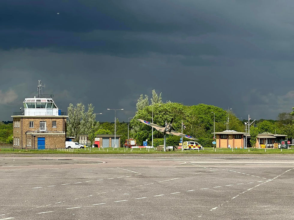 A view of North Weald Airport Air Traffic Control Tower with showers of rain in the distance relaying the importance of clearly understanding METARs