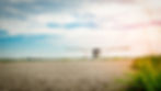 Small Jabiru airplane on a runway under a bright, cloudy sky. Grass lines the edge of the runway, creating a serene, open scene.