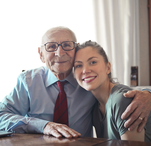 Older gentlemen and woman embrace at hospice