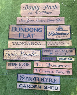 Collection of custom engraved timber signs including property, farm and garden shed names