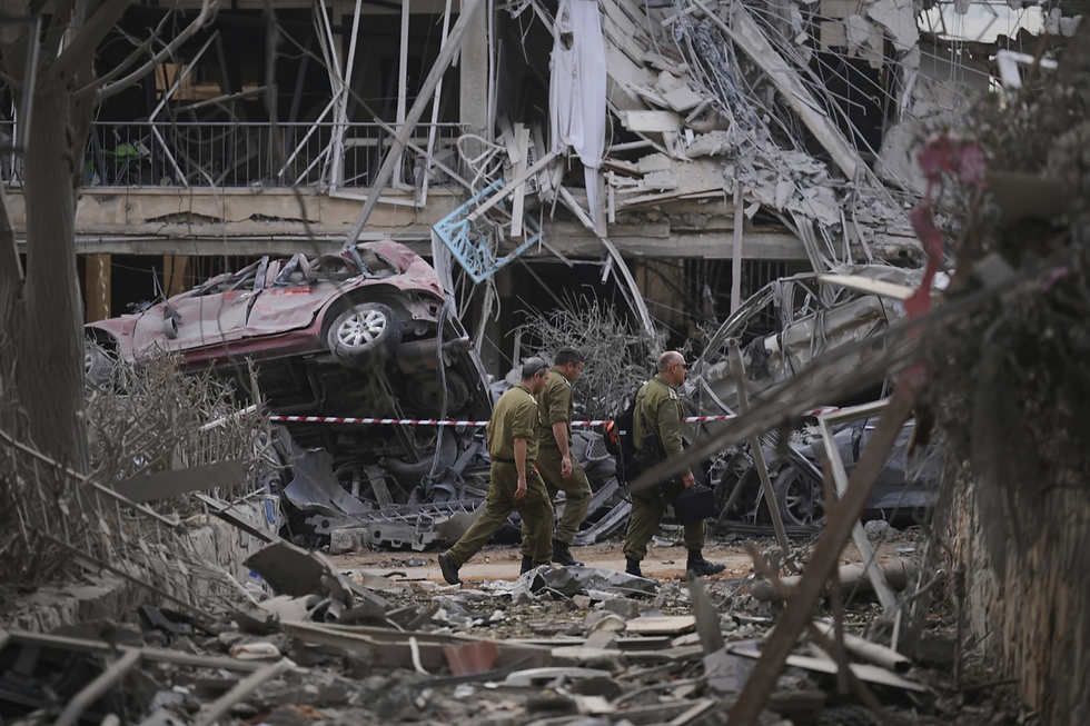 Isareli security forces inspect residential buildings that were destroyed by a missile from Iran in Ramat Gan, near TeL Aviv, Saturday, June 14, 2025