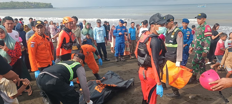 Rescuers carry a victim in a body bag after a ferry capsized off Indonesia’s Bali