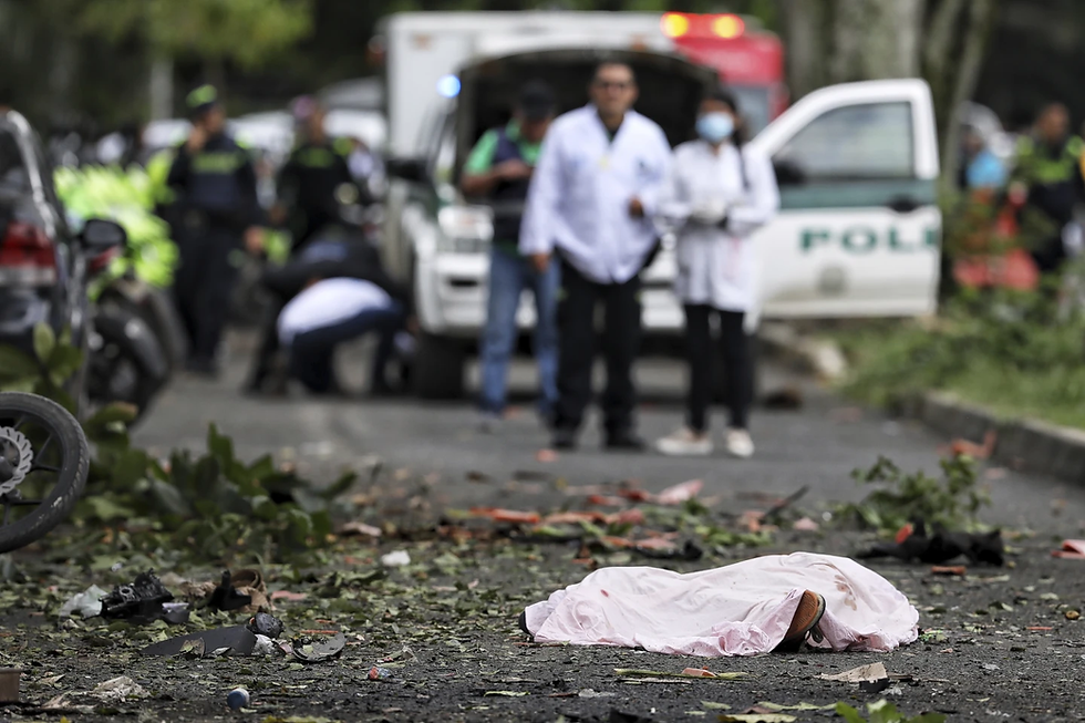 A body lies in the street, covered by a sheet, after a bomb explosion in Cali, Colombia, Tuesday, June 10, 2025