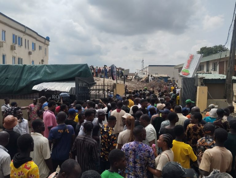 People at the site of the building collapse