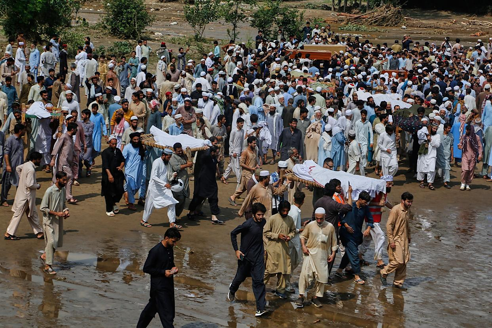 People carry bodies of victims of Friday's flash flooding, after funeral prayers at a village near Pir Baba, Buner district, in Pakistan's northwest, Saturday, Aug.16, 2025