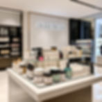 luxury product display with body scrubs and beauty items, clean marble surface, glossy lig