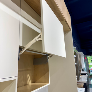 Modern garage-style cabinet door with hydraulic lift-up design for easy kitchen storage access in Naples Florida.