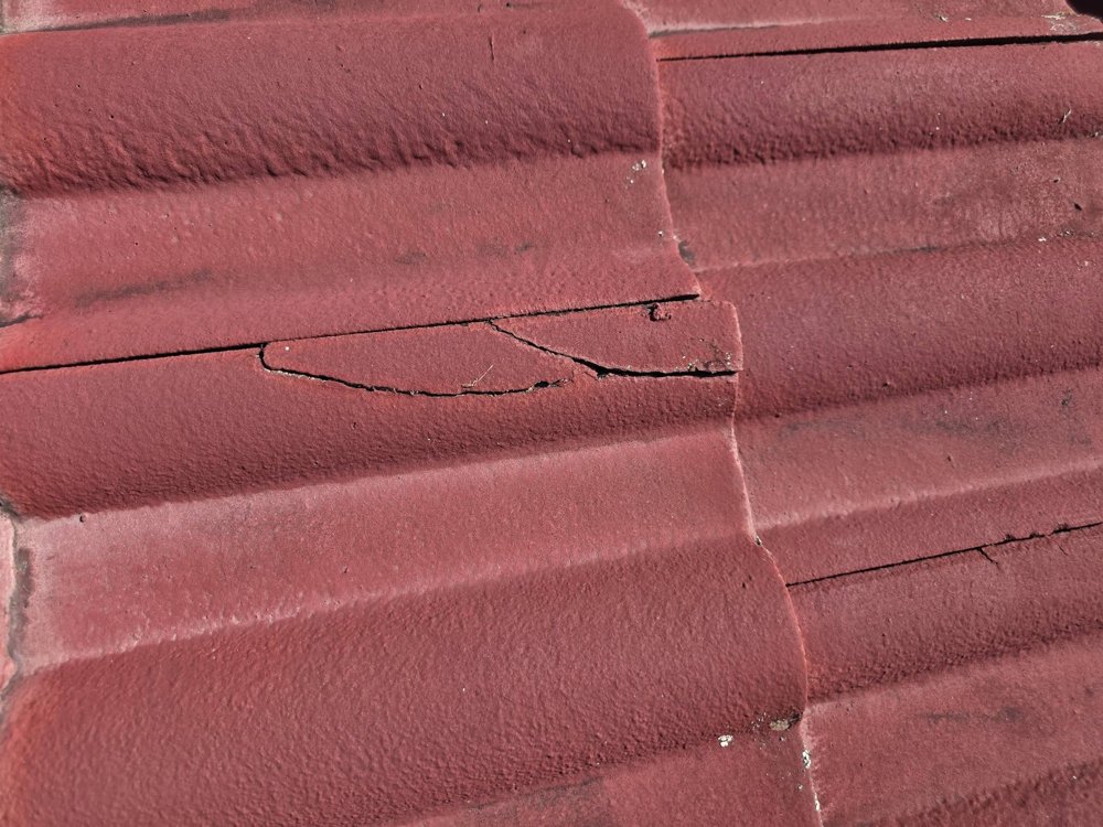 Close-up of a cracked roof tile where water can get in